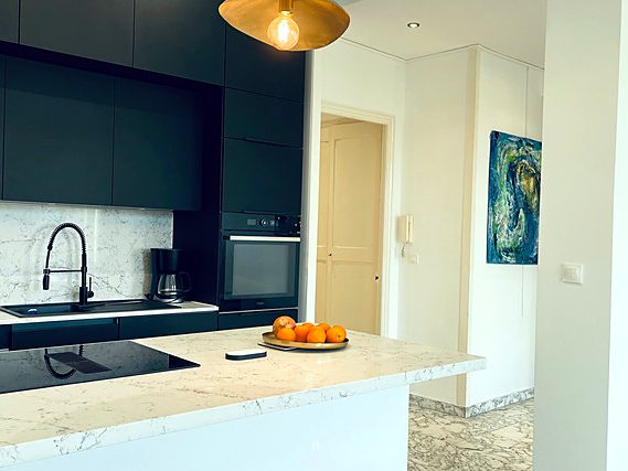 The kitchen’s marble worktop, a bowl of oranges