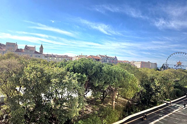 The view from the apartment: the Coulée Verte gardens, the rooftops of Nice and the Ferris wheel